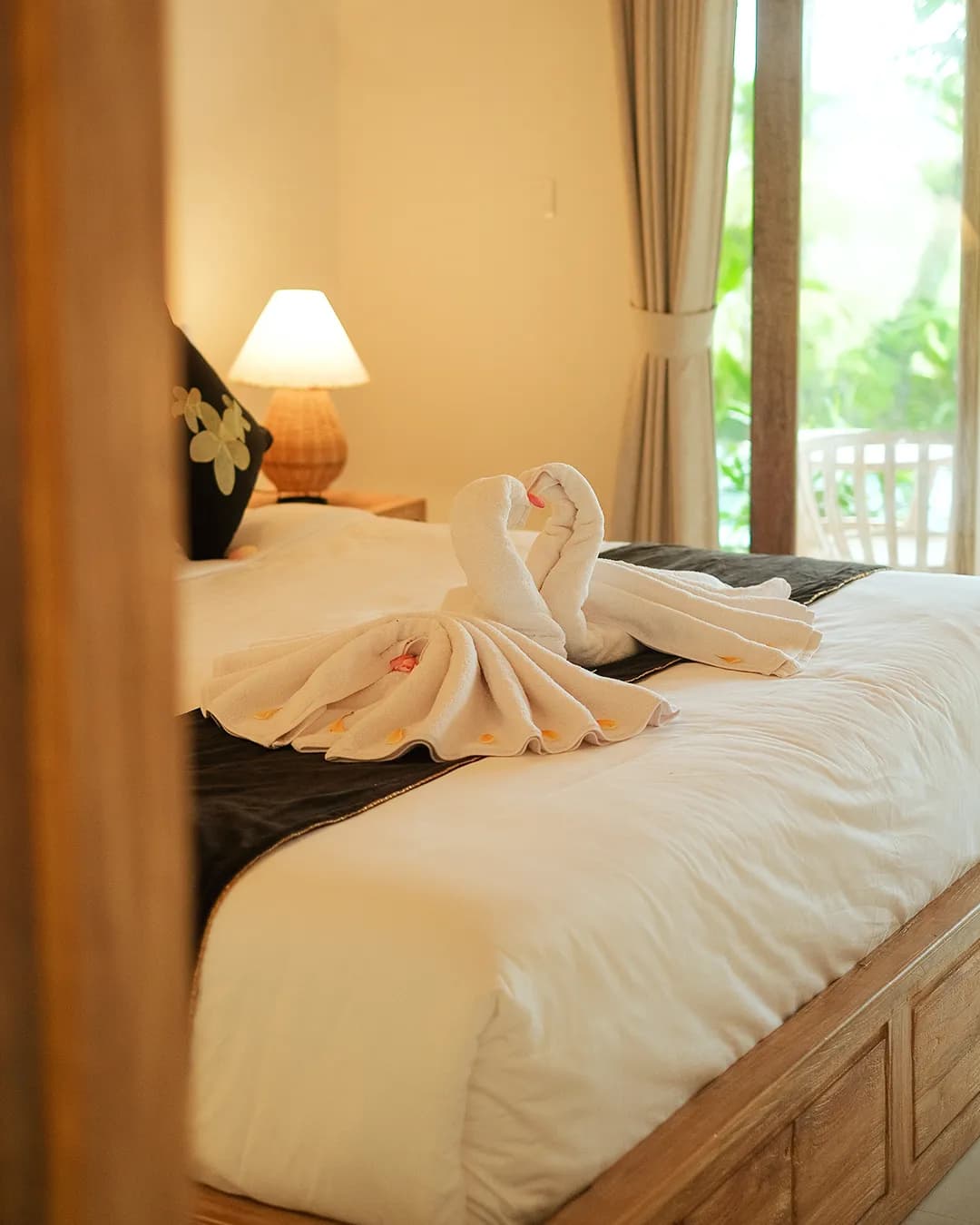 Cozy bedroom with large windows and garden view in Ubud villa